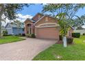 Charming one-story home with a brick driveway and American flag at 4068 Carteret Dr, Winter Haven, FL 33884