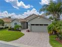 One-story house with a driveway and palm trees at 4489 Strathmore Dr, Lake Wales, FL 33859