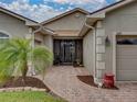 Front entry with a screened door and brick walkway at 4489 Strathmore Dr, Lake Wales, FL 33859