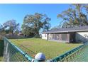 Spacious backyard with chain link fence at 5090 Misty Lake Dr, Mulberry, FL 33860