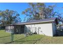 Home's back exterior, showing garage and fence at 5090 Misty Lake Dr, Mulberry, FL 33860