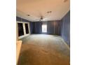 Large living room with blue walls and ceiling fan at 50989 Highway 27 # 8, Davenport, FL 33897