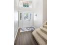 Bright entryway with modern flooring and a stunning glass front door at 523 Brookeshire Dr, Davenport, FL 33837