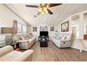 Spacious living room with light beige couches and wood-look flooring at 731 Polo Park Blvd, Davenport, FL 33897