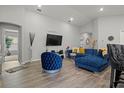 Open concept living room featuring a sectional sofa and hardwood floors at 1042 Corso Dr, Winter Haven, FL 33884