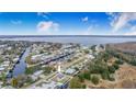 Aerial view showcasing home's waterfront lot and surrounding neighborhood at 13901 Hatchineha Rd, Haines City, FL 33844