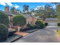 Spanish style home with driveway, landscaping, and attached garage at 2300 N Scenic Hwy # 37, Lake Wales, FL 33853