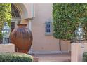 Spanish style home's entry with arched window, large urn, and brick walkway at 2300 N Scenic Hwy # 37, Lake Wales, FL 33853
