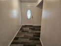 Bright entryway with tile flooring and a white door at 2314 York Pl, Lakeland, FL 33810