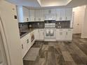 Newly renovated kitchen, white shaker cabinets, granite countertops at 2314 York Pl, Lakeland, FL 33810
