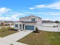 Two-story house with solar panels and fenced backyard at 245 Hillcrest Dr, Dundee, FL 33838