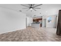 Open floor plan living room and kitchen with tile floors at 245 Hillcrest Dr, Dundee, FL 33838