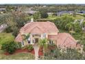 Luxury home with tile roof, landscaping, and a large backyard at 2683 Wyndsor Oaks Way, Winter Haven, FL 33884