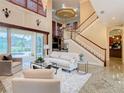 Spacious living room with high ceilings, fireplace and access to pool area at 2683 Wyndsor Oaks Way, Winter Haven, FL 33884