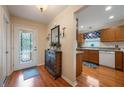 Bright entryway with hardwood floors and view into kitchen at 340 Lake Suzanne Dr, Lake Wales, FL 33859