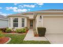 Well-maintained house with a two-car garage and landscaped front yard at 340 Lake Suzanne Dr, Lake Wales, FL 33859