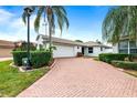 House exterior featuring brick driveway and lush landscaping at 3457 Raleigh Dr, Winter Haven, FL 33884