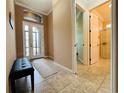 Bright and spacious entryway with tile flooring and bench at 3834 Litchfield Loop, Lake Wales, FL 33859