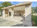 Covered carport with space for one car and additional storage area at 3966 Oak Loop # 13, Mulberry, FL 33860