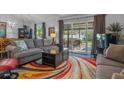 Spacious living room with comfy seating, large TV, and access to backyard at 3966 Oak Loop # 13, Mulberry, FL 33860