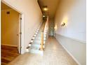 A view of a carpeted staircase with wooden handrail at 4193 Limerick Dr, Lake Wales, FL 33859
