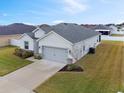 One-story home with gray garage and side yard at 425 Riders Loop, Auburndale, FL 33823