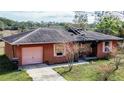 Fire-damaged house with visible roof damage from above at 517 Cipres Cir, Winter Haven, FL 33880