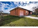 Fire damaged house with a pink garage door and boarded windows at 517 Cipres Cir, Winter Haven, FL 33880