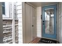 Inviting entryway with a blue door and storage closet at 524 Arneson Ave, Auburndale, FL 33823