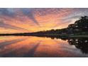 Stunning lakefront property with a vibrant sunset at 524 Arneson Ave, Auburndale, FL 33823