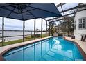 Relaxing screened-in pool with lake view at 524 Arneson Ave, Auburndale, FL 33823