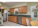 Kitchen features wood cabinets, stainless steel appliances, and a breakfast nook at 615 E Haines Blvd, Lake Alfred, FL 33850