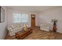 Living room with floral sofas, wood floors, and coffee table at 615 E Haines Blvd, Lake Alfred, FL 33850