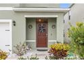 Inviting front door with wreath and landscaping at 723 Chinoy Rd, Davenport, FL 33837