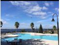 Relaxing community pool with lake views and ample seating at 780 Waterfern Trail Dr, Auburndale, FL 33823