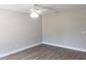 A bright bedroom featuring durable wood-look flooring and a modern ceiling fan at 809 Lincoln St, Babson Park, FL 33827
