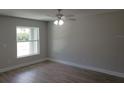 Bright bedroom features modern ceiling fan, a large window, and durable wood-look flooring at 809 Lincoln St, Babson Park, FL 33827