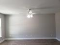 A spacious living area with modern light fixture, durable wood-look flooring, and neutral paint at 809 Lincoln St, Babson Park, FL 33827