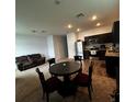 Modern kitchen with dark brown cabinets and stainless steel appliances at 932 Grandin St, Davenport, FL 33837
