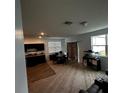 Open concept living room and kitchen with carpeted floors at 932 Grandin St, Davenport, FL 33837