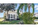 Two-story house with a brown garage door and palm trees at 1153 Legatto Loop, Dundee, FL 33838
