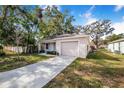 Newly built home with a landscaped yard and driveway at 124 A St, Haines City, FL 33844