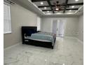 Comfortable main bedroom with a ceiling fan and elegant tile flooring at 2510 Lakefront Dr, Lake Wales, FL 33898