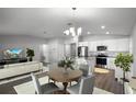 Open-concept living and dining area features stylish decor and a modern kitchen with stainless steel appliances at 264 Spirit Landings Cir, Winter Haven, FL 33880