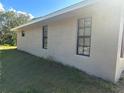 Tan colored home with multiple dark framed windows and ample light at 2772 Indian Pipes Trl, Frostproof, FL 33843