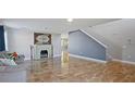 Living room with tiled floors, fireplace, and staircase at 343 Drum Ct, Kissimmee, FL 34759
