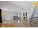 Spacious living room with tiled floors, fireplace, and staircase at 343 Drum Ct, Kissimmee, FL 34759