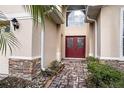 Home's entry features a red double door and a brick walkway at 3526 Valleyview Dr, Kissimmee, FL 34746