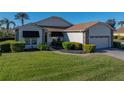 Well-maintained house with a lush lawn, paver driveway, and garage at 4195 Muirfield Loop, Lake Wales, FL 33859