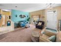 Spacious living room with teal walls, comfortable seating, and ample natural light at 4195 Muirfield Loop, Lake Wales, FL 33859